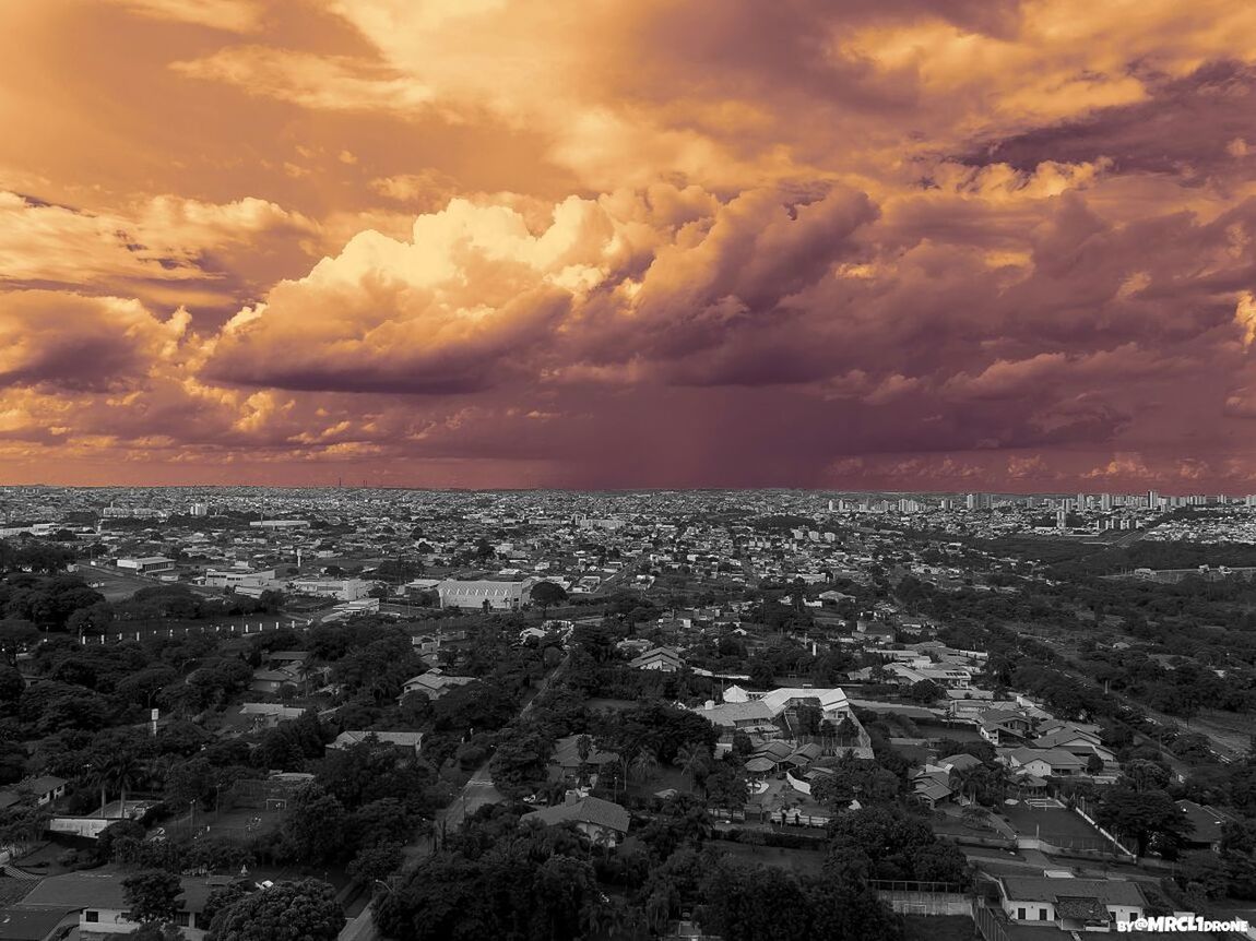 AERIAL VIEW OF CITY AGAINST CLOUDY SKY