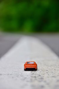 Close-up of red toy car on road