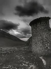 Old building on mountain against sky