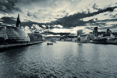 Boats in river with buildings in background