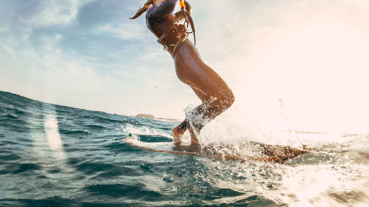 MAN SPLASHING WATER IN SEA