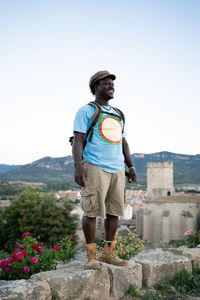 Black african american man with green backpack, travel concept