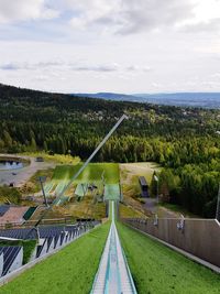 High angle view of green landscape against sky