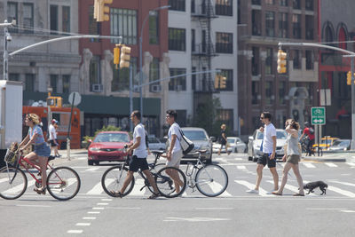 People riding bicycles on street in city