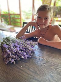 Portrait of girl sitting on table