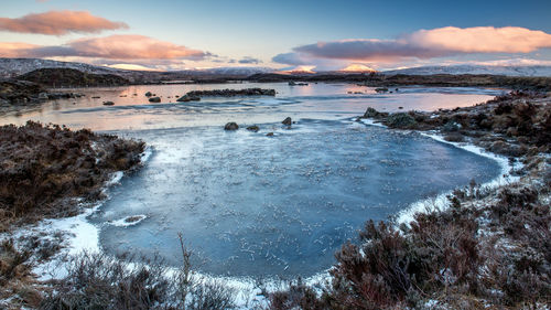 Sunrise over a frozen lochan na h achlaise rannoch moor near  glencoe in the scottish highlands