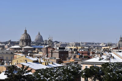 High angle view of buildings in city against clear sky