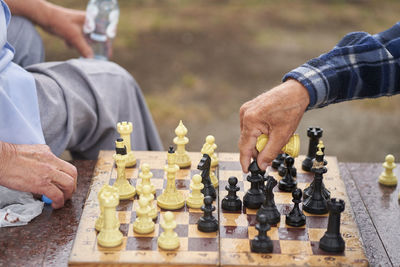 Midsection of man playing chess