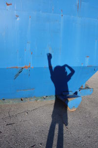 Woman standing against blue sky