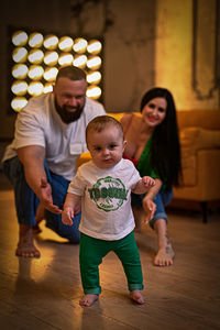 Young family ,father mother and son posing in photo studio