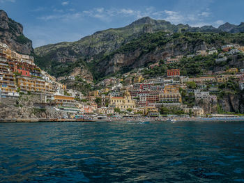 Scenic view of sea and buildings in city