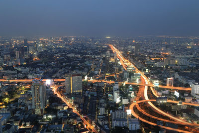 Aerial view of illuminated buildings in city at night