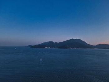 Scenic view of sea against clear sky during sunset