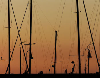 Low angle view of silhouette sailboats against sky during sunset