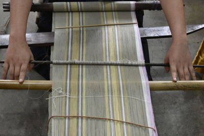 Rural women weaving with traditional weaving equipment or weaving loom.