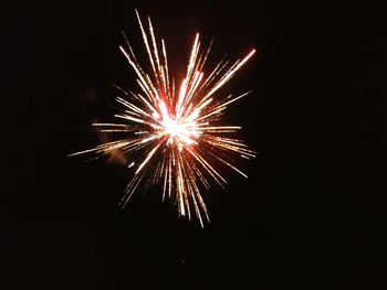 Low angle view of firework display at night