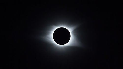 Low angle view of silhouette moon against sky at night