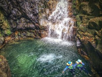 High angle view of waterfall amidst rocks