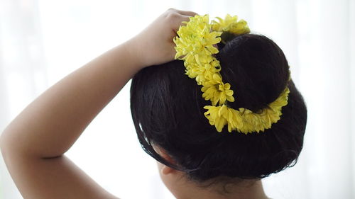 Rear view of woman with pink flower