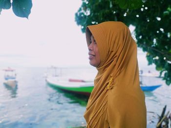 Side view of woman looking at boat