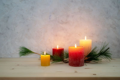 Close-up of illuminated candles on table