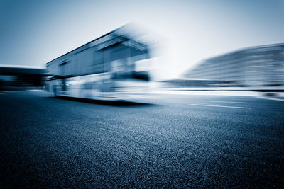 Blurred motion of city street against clear sky