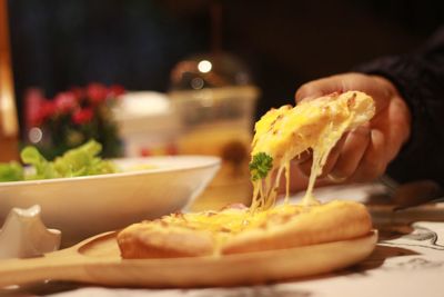 Close-up of person preparing food in plate