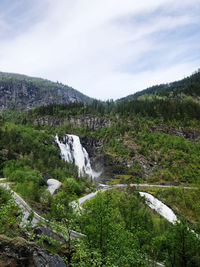 Scenic view of waterfall against sky