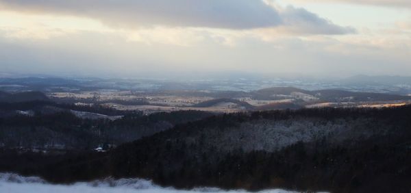 Scenic view of landscape against sky during winter
