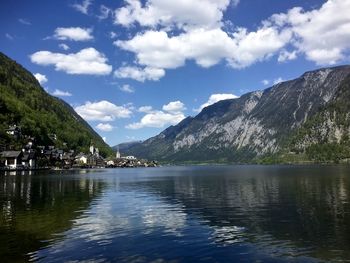 Scenic view of lake by mountains against sky