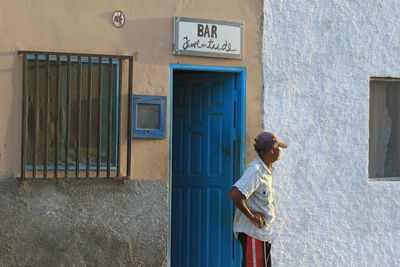 Full length of a man walking in front of building