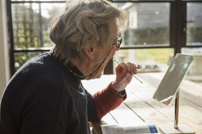 Side view of woman sitting on seat