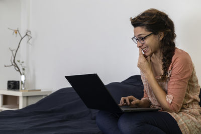 Young woman using laptop at home