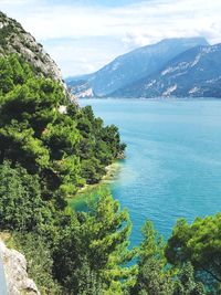 Scenic view of sea and mountains against sky