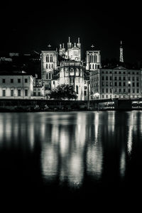 Reflection of buildings in city at waterfront