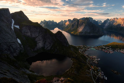 Scenic view of lake and fjord amidst moutains against sky during sunset