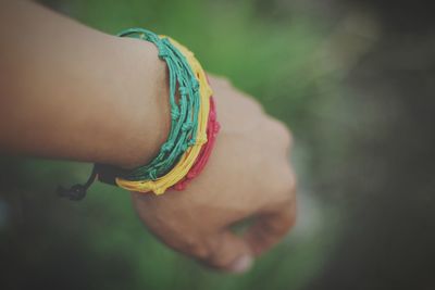 Cropped hand with colorful bracelets