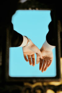 Close-up of hands reflecting mirror