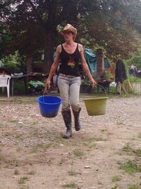 Full length of woman standing on tree trunk