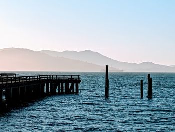 Pier over sea against clear sky