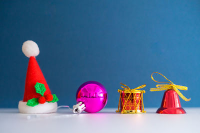 Multi colored christmas decoration against blue background
