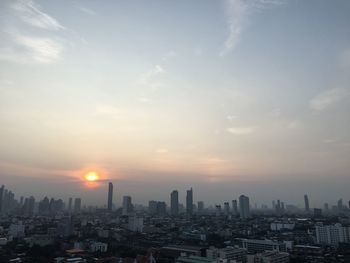 Cityscape against sky during sunset