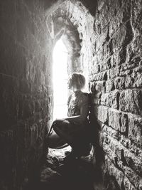 Woman sitting on wall