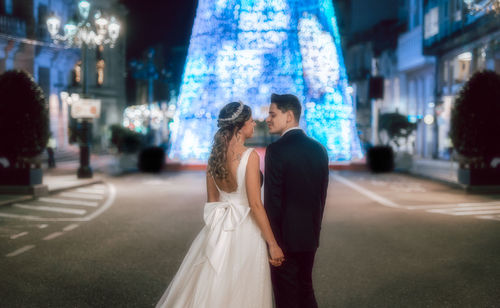 Full length of couple standing in city