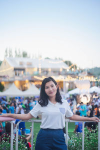 Portrait of smiling young woman standing outdoors