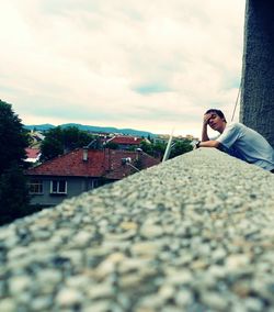 Silhouette of woman standing against cloudy sky
