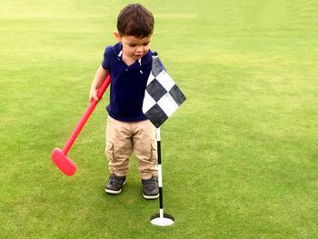 Boy playing on golf course