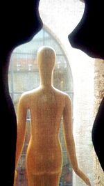 Close-up of silhouette man standing against window