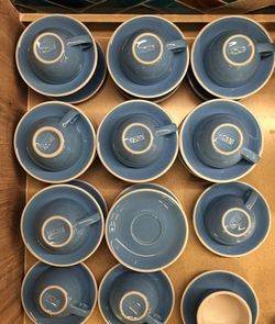 High angle view of cups with saucers arranged on table