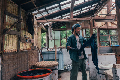 Full length of man working in building